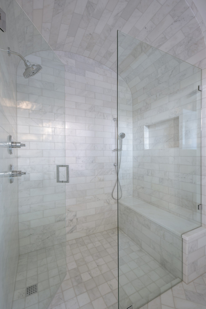 Идея дизайна: главная ванная комната в морском стиле с фасадами в стиле шейкер, синими фасадами, отдельно стоящей ванной, душем без бортиков, раздельным унитазом, белой плиткой, мраморной плиткой, белыми стенами, мраморным полом, врезной раковиной, мраморной столешницей, белым полом, душем с распашными дверями, серой столешницей, сиденьем для душа, тумбой под две раковины, встроенной тумбой и балками на потолке