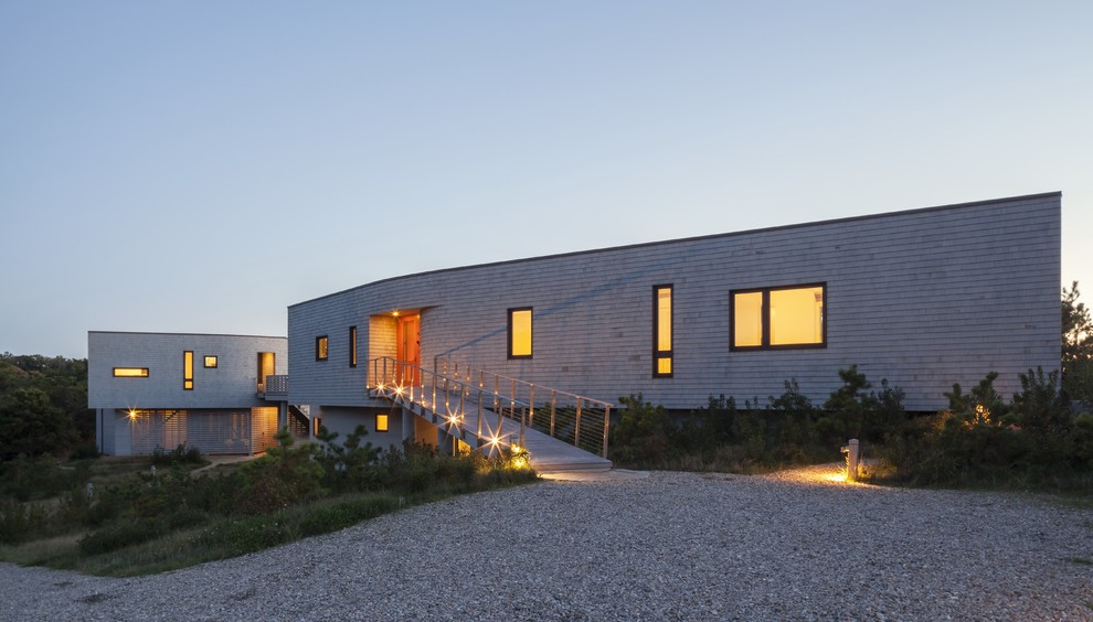 Inspiration for a contemporary two-story wood flat roof remodel in Boston