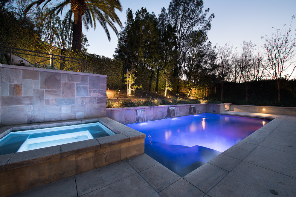 Mid-sized modern backyard custom-shaped pool in Orange County with concrete slab.
