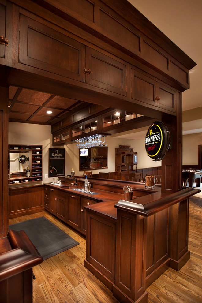 Photo of a large traditional u-shaped seated home bar in DC Metro with flat-panel cabinets, medium wood cabinets, wood benchtops and brown benchtop.