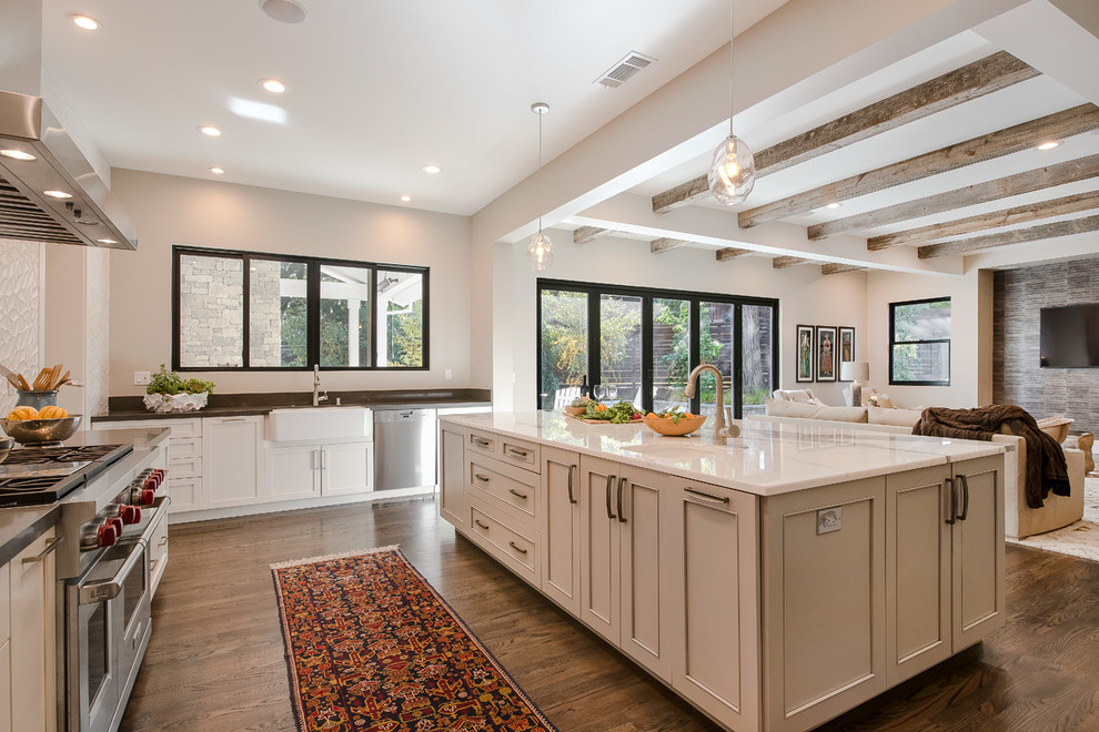 Transitional open plan kitchen in San Francisco with a farmhouse sink, recessed-panel cabinets, white cabinets, dark hardwood floors and with island.