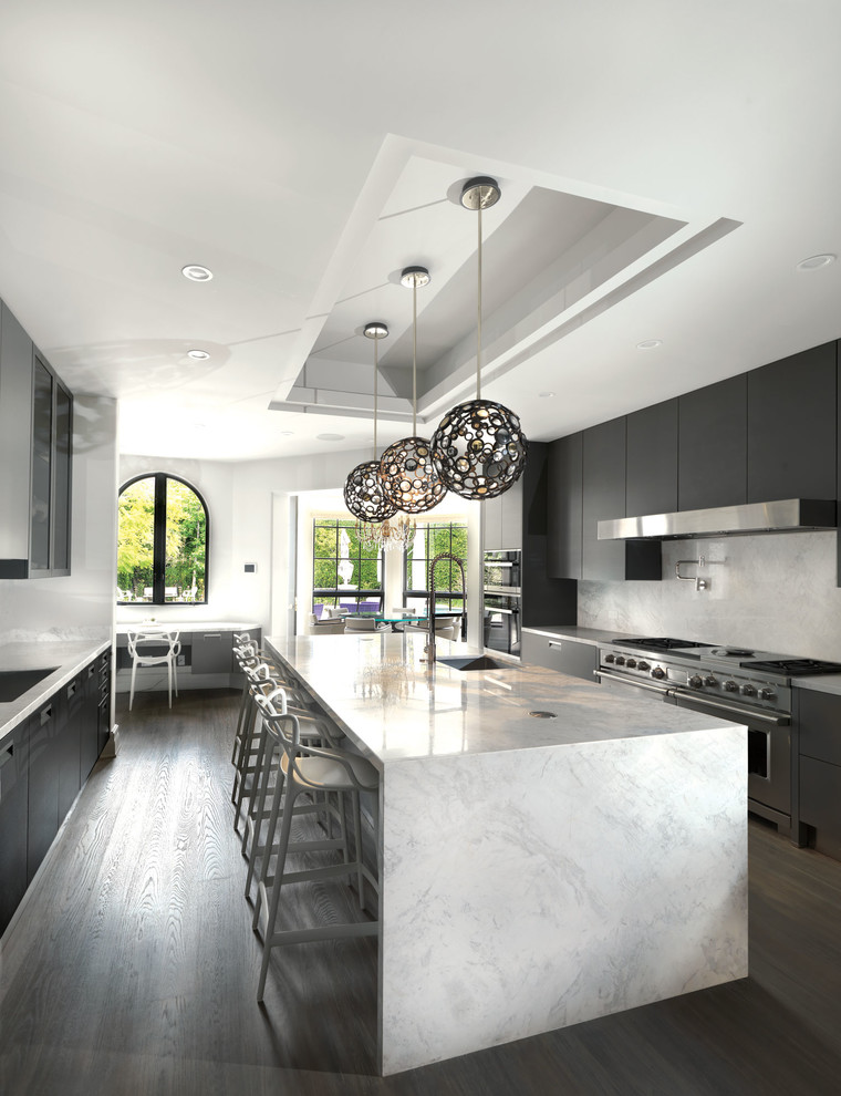 Photo of a large modern u-shaped open plan kitchen in Los Angeles with an undermount sink, flat-panel cabinets, grey cabinets, marble benchtops, grey splashback, marble splashback, stainless steel appliances, dark hardwood floors, with island, brown floor and grey benchtop.