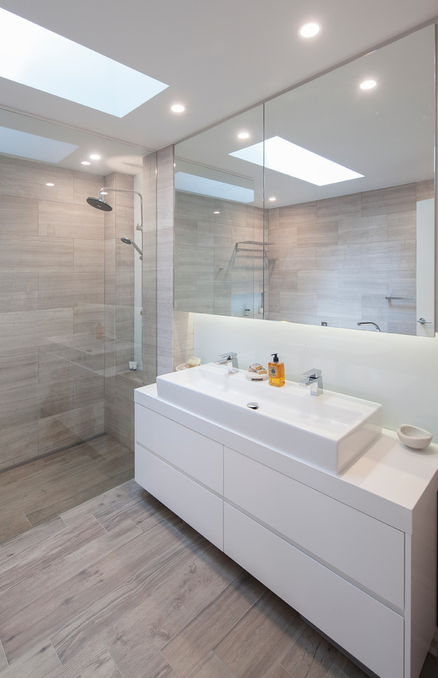 Contemporary bathroom in Sydney with gray tile, stone tile, grey walls and porcelain floors.
