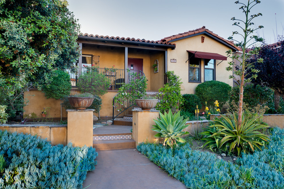 This is an example of a mid-sized transitional one-storey stucco yellow exterior in San Diego.