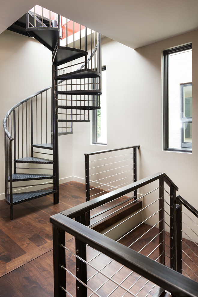 Photo of a small modern metal spiral staircase in Minneapolis with open risers.