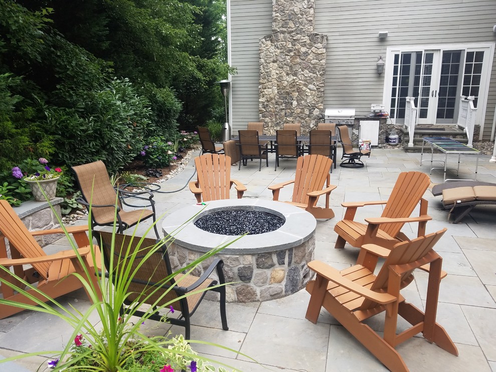 Large traditional backyard patio in New York with a fire feature and no cover.
