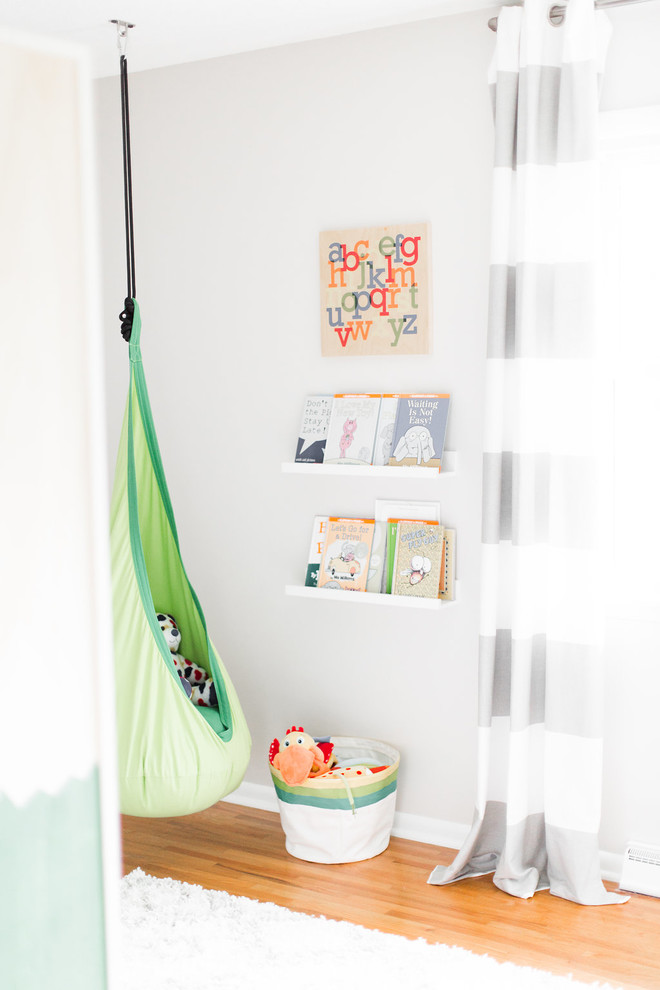 Inspiration for a mid-sized country kids' bedroom for kids 4-10 years old and boys in Minneapolis with brown floor, grey walls and medium hardwood floors.