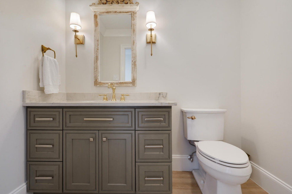 Mid-sized transitional bathroom in New Orleans with flat-panel cabinets, grey cabinets, white walls, light hardwood floors, an undermount sink, engineered quartz benchtops, brown floor, white benchtops, a single vanity and a built-in vanity.