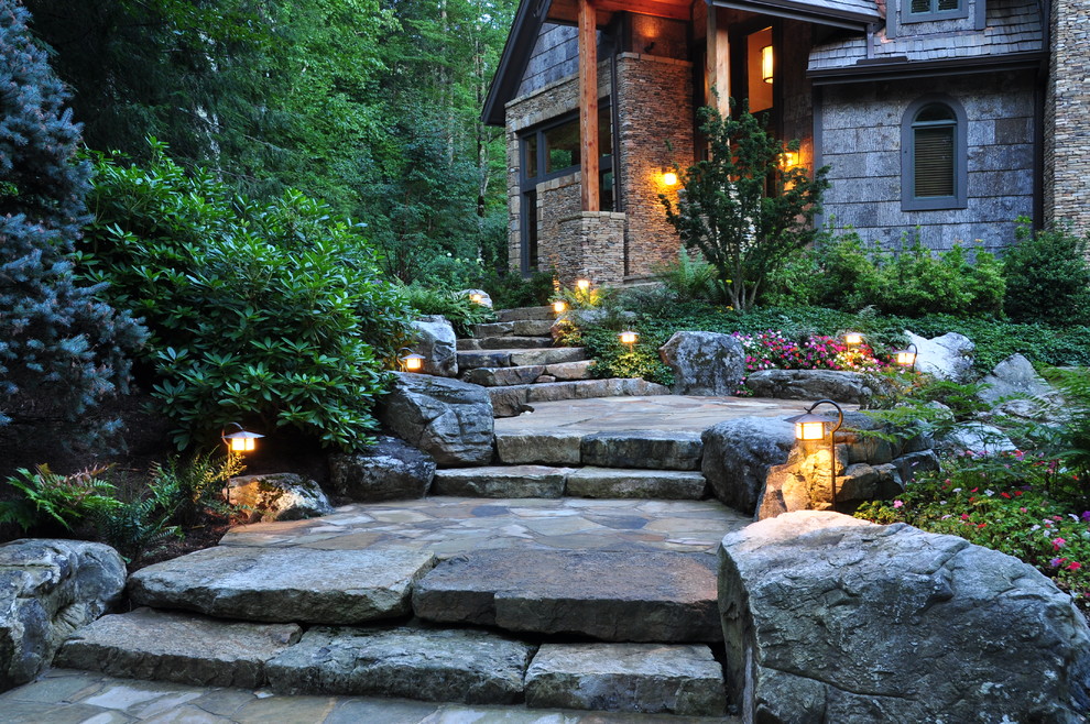 Photo of a country front yard garden in Other with a garden path and natural stone pavers.