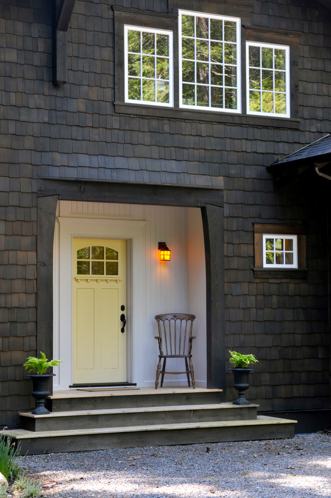 Photo of a traditional entryway in Vancouver with a yellow front door.