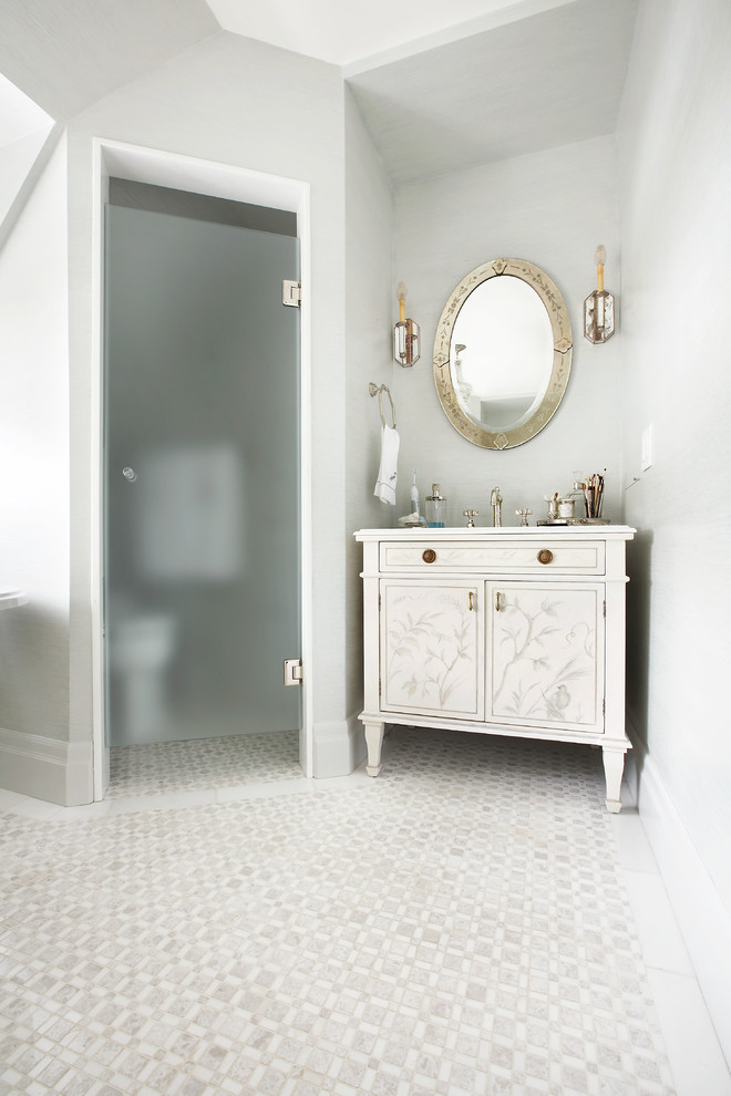 Photo of a traditional bathroom in Toronto with a freestanding tub, an alcove shower, white tile, mosaic tile and marble floors.