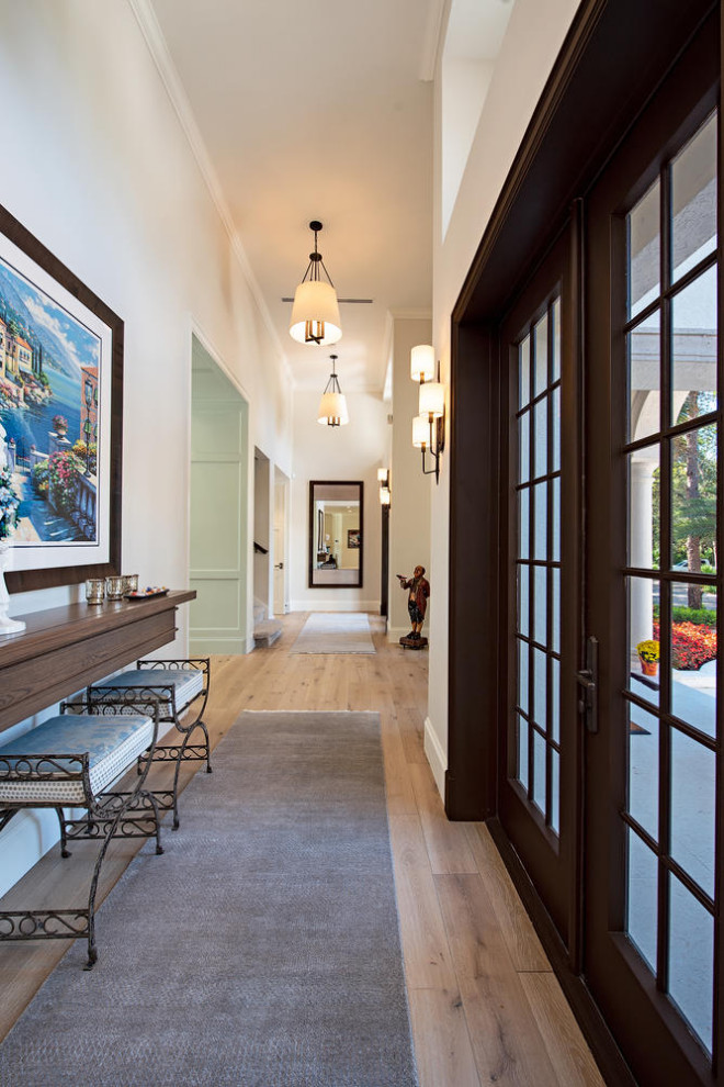 Large mediterranean hallway in Other with white walls, light hardwood floors and brown floor.