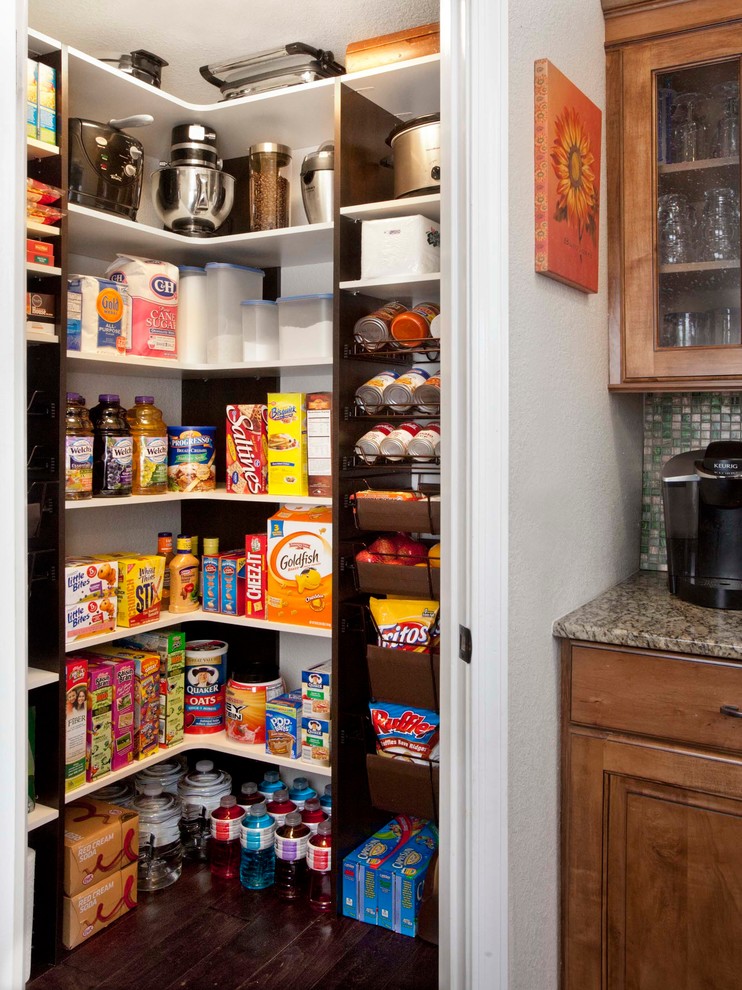 This is an example of a small traditional kitchen pantry in Charleston with open cabinets, white cabinets, medium hardwood floors and brown floor.