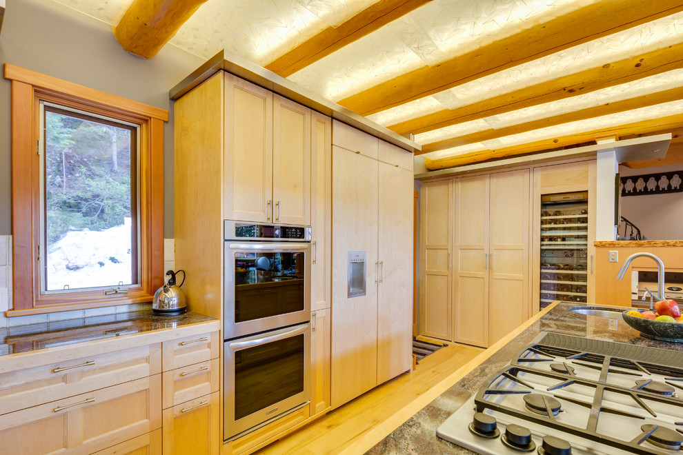 Mid-sized mountain style light wood floor eat-in kitchen photo in Vancouver with recessed-panel cabinets, light wood cabinets, stainless steel appliances and an island