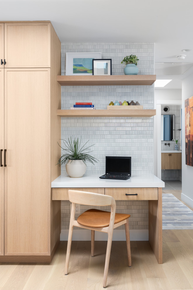 Inspiration for a large contemporary light wood floor and brown floor home office remodel in San Francisco with gray walls