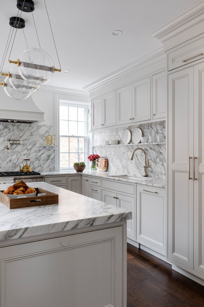 Enclosed kitchen - small transitional l-shaped dark wood floor and brown floor enclosed kitchen idea in Boston with an undermount sink, shaker cabinets, white cabinets, marble countertops, white backsplash, marble backsplash, paneled appliances, an island and white countertops
