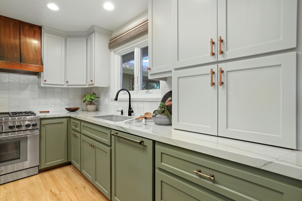 Inspiration for a modern eat-in kitchen remodel in Sacramento with an undermount sink, shaker cabinets, green cabinets, quartzite countertops, white backsplash, ceramic backsplash, paneled appliances, an island and gray countertops