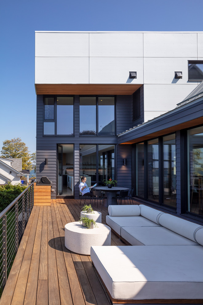 Photo of a large contemporary first floor deck in Other with mixed railing.