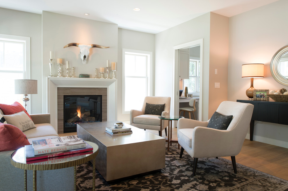Photo of a beach style open concept living room in Minneapolis with beige walls and light hardwood floors.