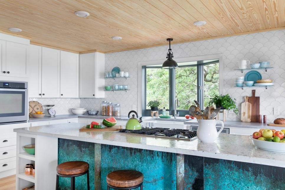 Inspiration for a large beach style l-shaped open plan kitchen in Other with a farmhouse sink, shaker cabinets, yellow cabinets, terrazzo benchtops, white splashback, ceramic splashback, stainless steel appliances, bamboo floors and multiple islands.