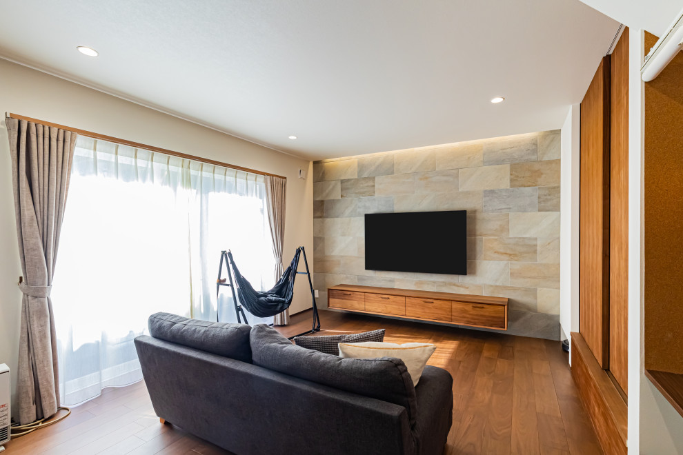 Foto på ett mellanstort funkis allrum med öppen planlösning, med vita väggar, mellanmörkt trägolv, en väggmonterad TV och brunt golv