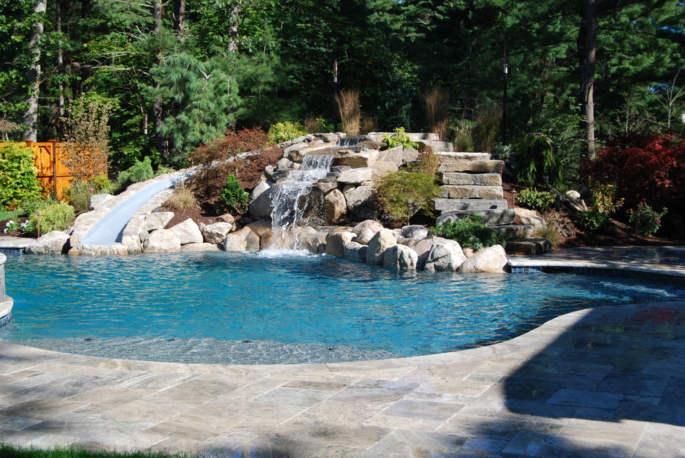 Inspiration for a mid-sized country backyard kidney-shaped natural pool in Boston with a water slide and natural stone pavers.