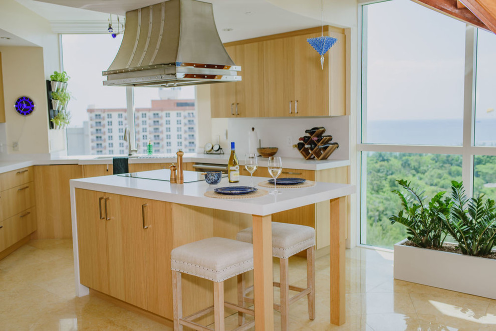 Open concept kitchen - mid-sized transitional u-shaped porcelain tile and beige floor open concept kitchen idea in Miami with an undermount sink, flat-panel cabinets, light wood cabinets, quartz countertops, white backsplash, stainless steel appliances, an island and white countertops