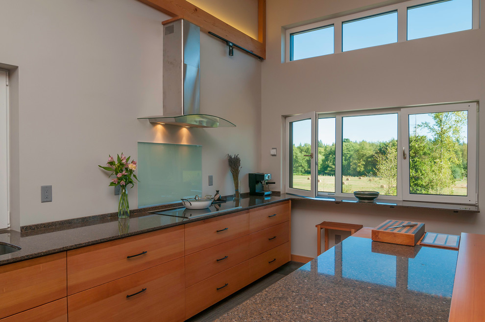 Photo of a large contemporary l-shaped open plan kitchen in Seattle with an undermount sink, flat-panel cabinets, medium wood cabinets, terrazzo benchtops, stainless steel appliances, light hardwood floors and with island.