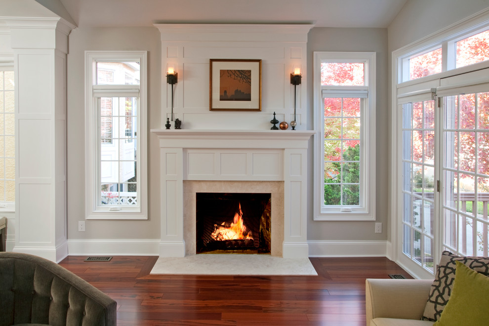 Design ideas for a large transitional formal open concept living room in Philadelphia with grey walls, medium hardwood floors, a standard fireplace, a wood fireplace surround and no tv.