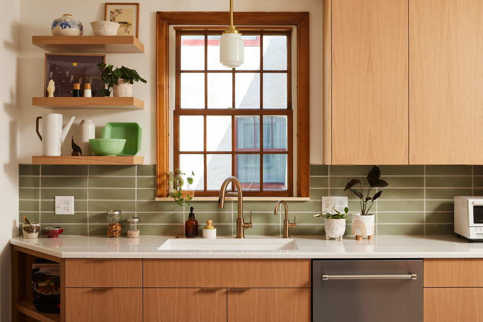 Design ideas for a mid-sized scandinavian galley separate kitchen in Minneapolis with an undermount sink, flat-panel cabinets, light wood cabinets, quartz benchtops, green splashback, ceramic splashback, stainless steel appliances, porcelain floors, a peninsula, grey floor and white benchtop.