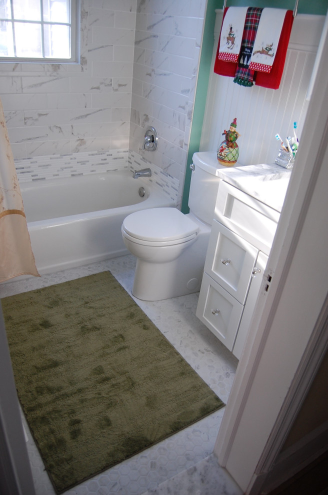 Small traditional master bathroom in Baltimore with recessed-panel cabinets, white cabinets, an alcove tub, a shower/bathtub combo, a one-piece toilet, multi-coloured tile, ceramic tile, green walls, ceramic floors, an undermount sink, granite benchtops, multi-coloured floor, a shower curtain and white benchtops.