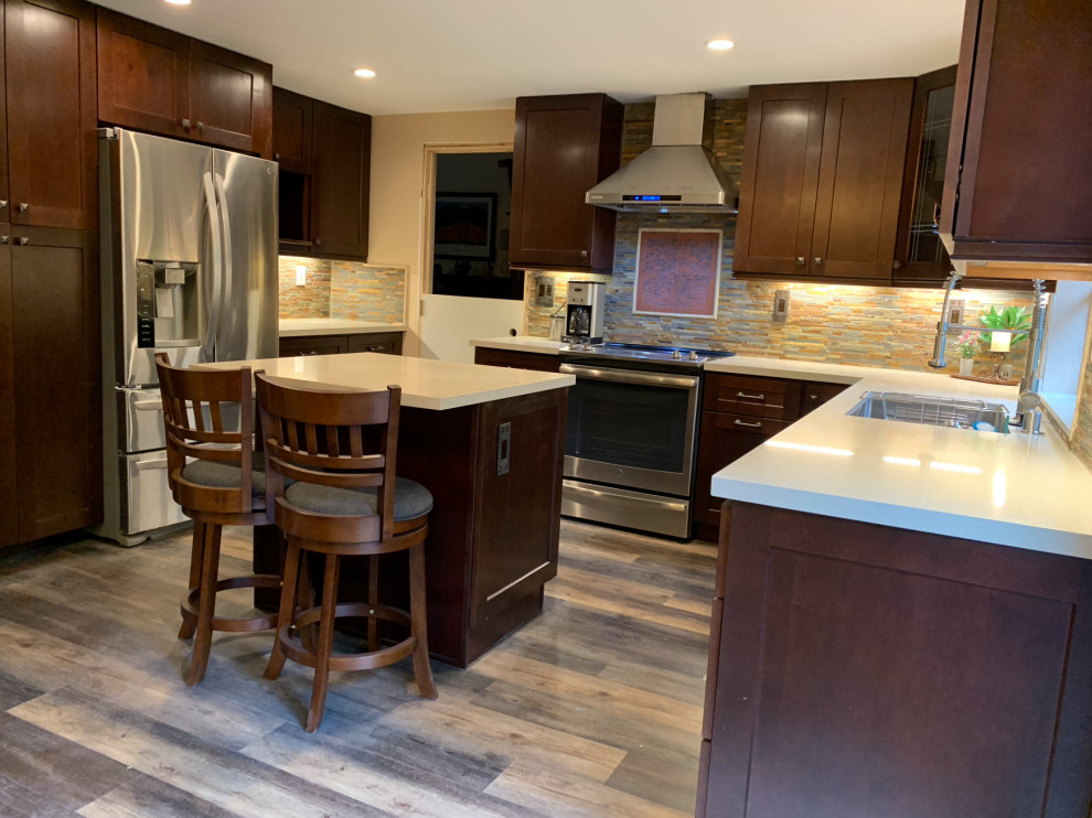 This is an example of a mid-sized traditional u-shaped separate kitchen in San Francisco with an undermount sink, louvered cabinets, dark wood cabinets, quartzite benchtops, multi-coloured splashback, stone tile splashback, stainless steel appliances, medium hardwood floors, with island, beige floor and beige benchtop.