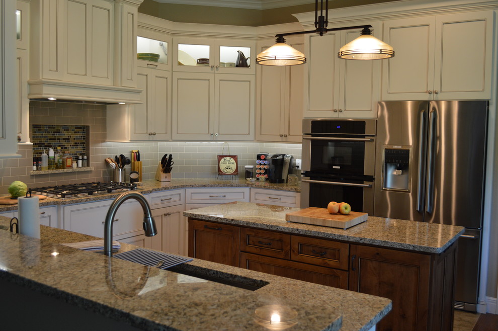 Inspiration for a mid-sized timeless u-shaped ceramic tile and brown floor open concept kitchen remodel with an undermount sink, beaded inset cabinets, white cabinets, granite countertops, gray backsplash, subway tile backsplash, stainless steel appliances, an island and gray countertops