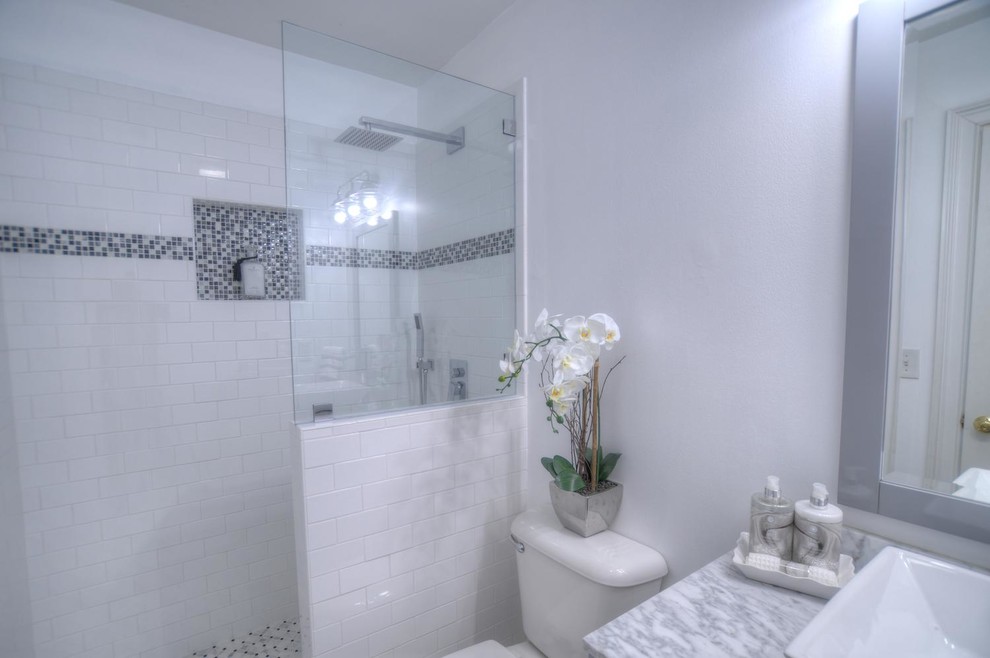 Traditional 3/4 bathroom in Other with shaker cabinets, white cabinets, a freestanding tub, an alcove shower, white tile, subway tile, white walls, a vessel sink, marble benchtops, an open shower, a two-piece toilet and white floor.