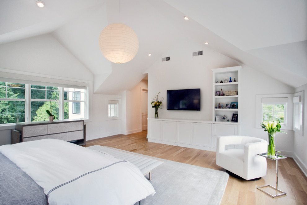 Expansive modern master bedroom in New York with white walls, light hardwood floors, no fireplace and beige floor.