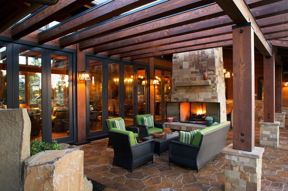 Photo of a country patio in Portland with a fire feature and a pergola.