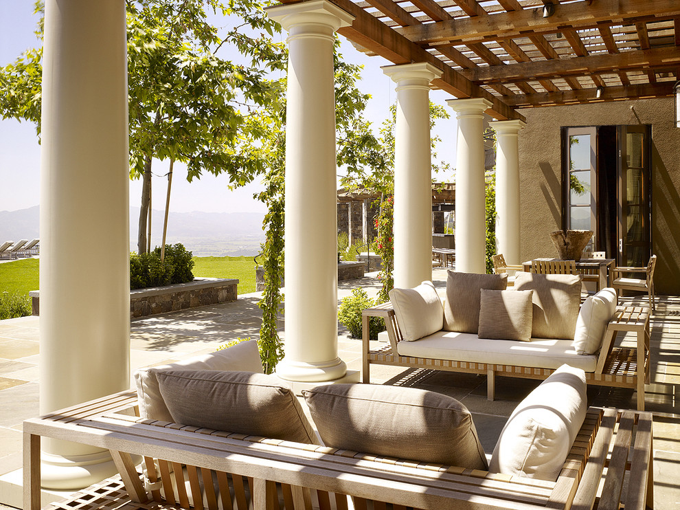 Inspiration for a traditional patio in San Francisco with natural stone pavers and a pergola.