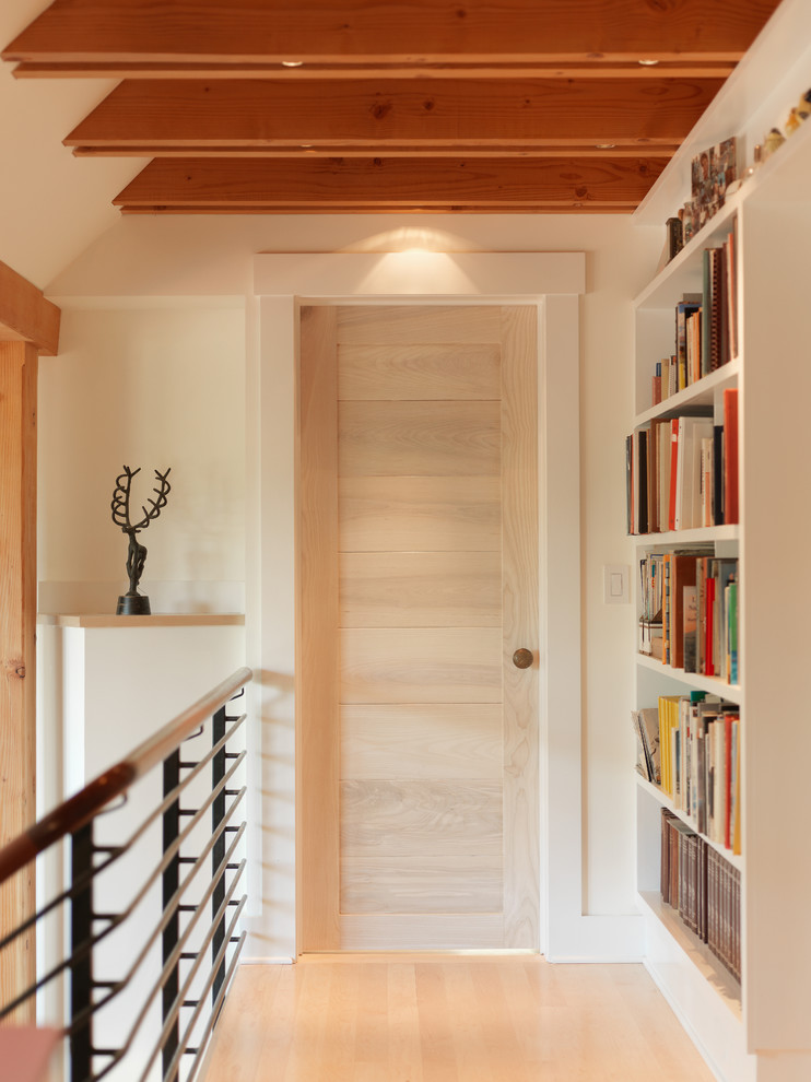 Inspiration for a contemporary hallway in Burlington with beige walls, light hardwood floors and beige floor.