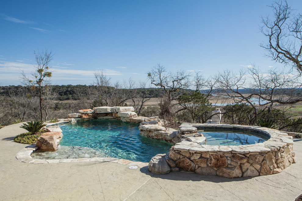 Hot tub - small rustic backyard stamped concrete hot tub idea in Austin