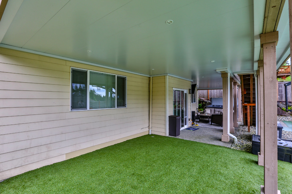 This is an example of a large modern backyard verandah in Seattle.