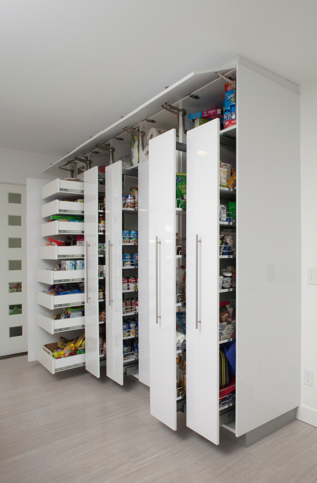 Inspiration for a large modern travertine floor kitchen pantry remodel in New York with an undermount sink, flat-panel cabinets, white cabinets, quartz countertops, white backsplash, stone slab backsplash, paneled appliances and no island