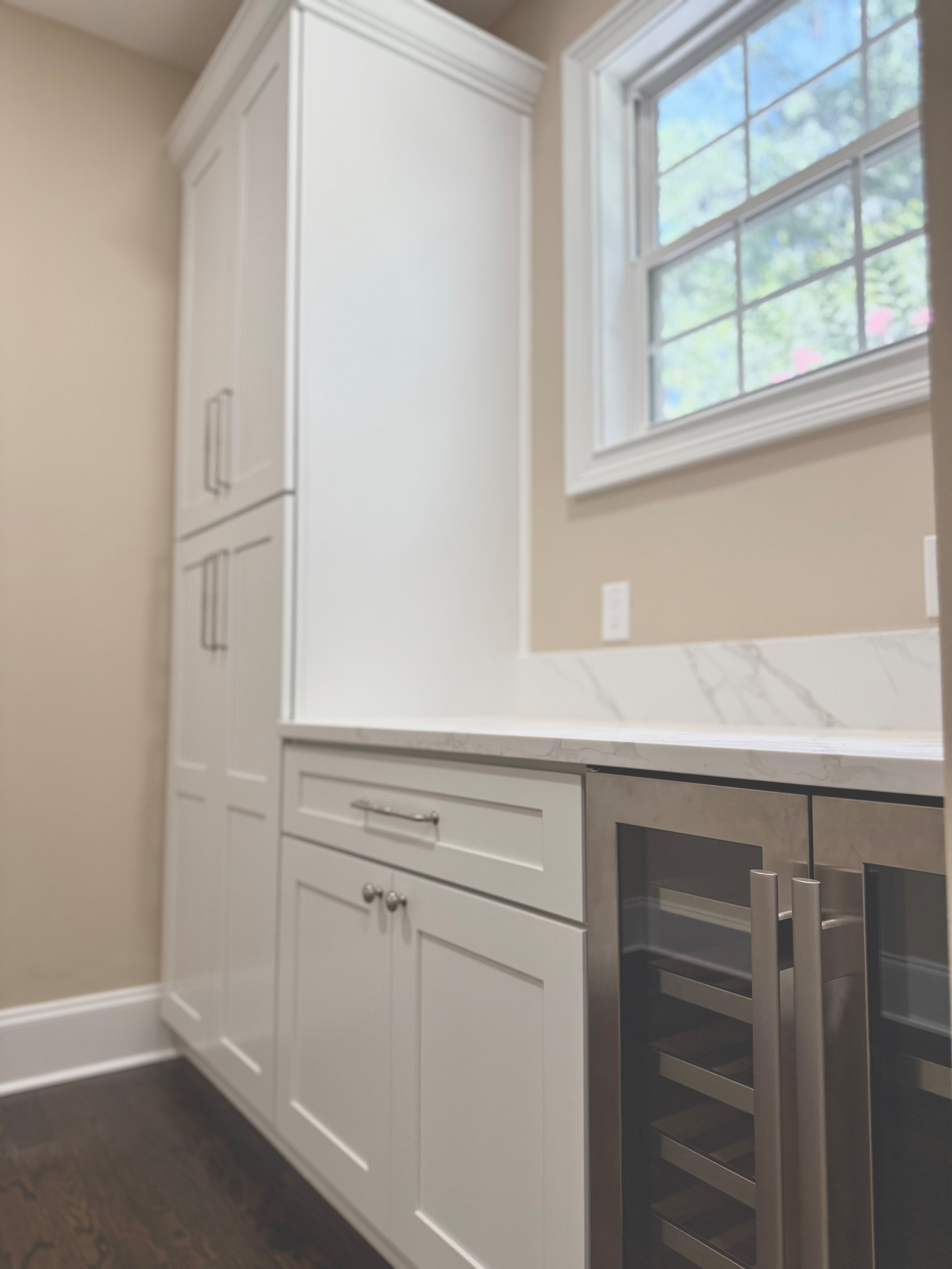 Storage and countertop space were a must for this pantry. The integrated wine cooler, and roll out trays take this space to the next level of functionality.