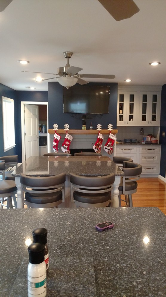Kitchen - huge transitional l-shaped kitchen idea in Boston with flat-panel cabinets, gray cabinets, quartz countertops, wood backsplash and two islands