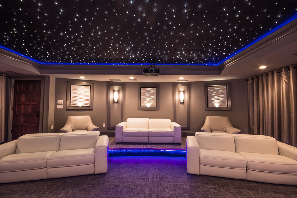 Large contemporary enclosed home theatre in Atlanta with grey walls, carpet, a projector screen and grey floor.