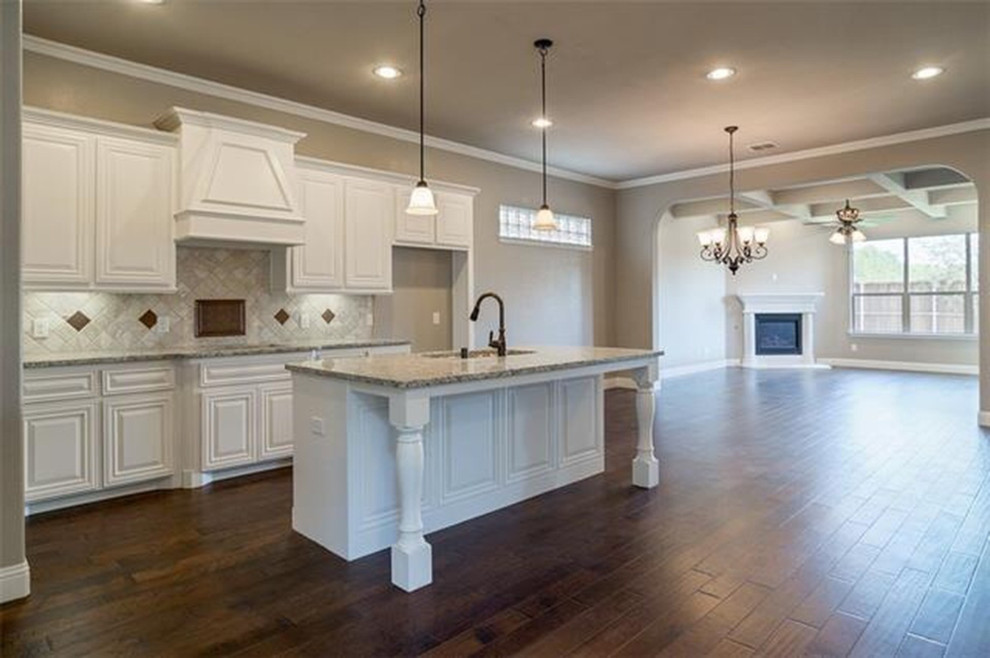 Open concept kitchen - large transitional l-shaped dark wood floor open concept kitchen idea with raised-panel cabinets, white cabinets, beige backsplash, colored appliances, an island and a double-bowl sink