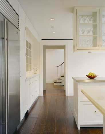 Inspiration for a mid-sized contemporary u-shaped eat-in kitchen in New York with an undermount sink, recessed-panel cabinets, white cabinets, marble benchtops, white splashback, stainless steel appliances, medium hardwood floors, with island and brown floor.