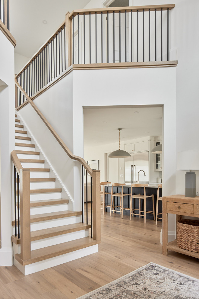 Inspiration for a large transitional wooden straight wood railing staircase remodel with wooden risers