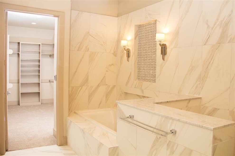 Design ideas for a mid-sized mediterranean master bathroom in Dallas with shaker cabinets, beige cabinets, a drop-in tub, an open shower, a two-piece toilet, marble, beige walls, porcelain floors, an undermount sink, marble benchtops, beige floor and a hinged shower door.
