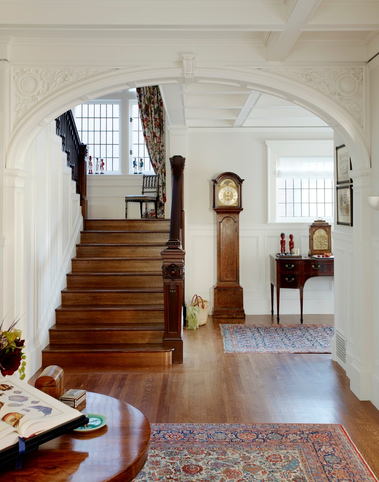 This is an example of a large traditional foyer in San Francisco with white walls and medium hardwood floors.
