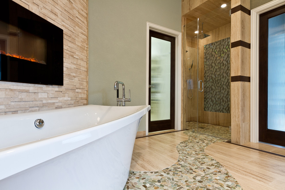 Design ideas for a large contemporary master bathroom in Houston with beige tile, a vessel sink, a freestanding tub, a curbless shower, a one-piece toilet, pebble tile, grey walls and terrazzo floors.